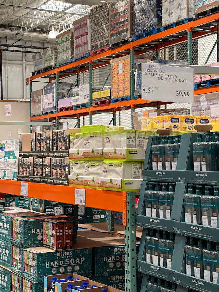 Bulk products displayed on shelves in a wholesale warehouse setting.